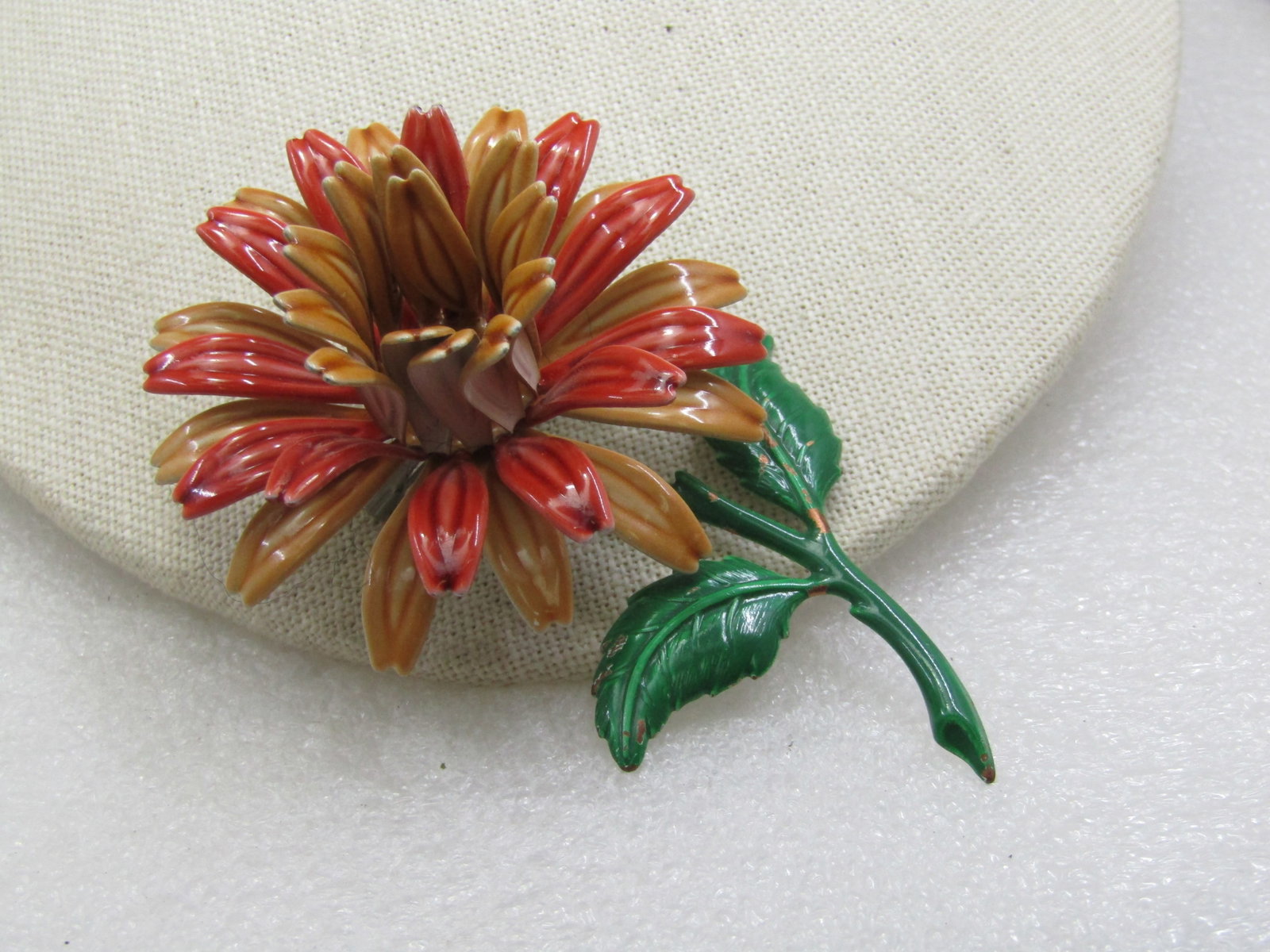 Vintage Enameled Dahlia Floral Brooch, 3.75", 1960's: Vintage Enameled Dahlia Floral Brooch, 3.75" tall and 2.25" wide., 1960's. Enameled in orange and tan with a raised center and tiered petals with a green stem. 3-D brooch, will be noticed when worn. t