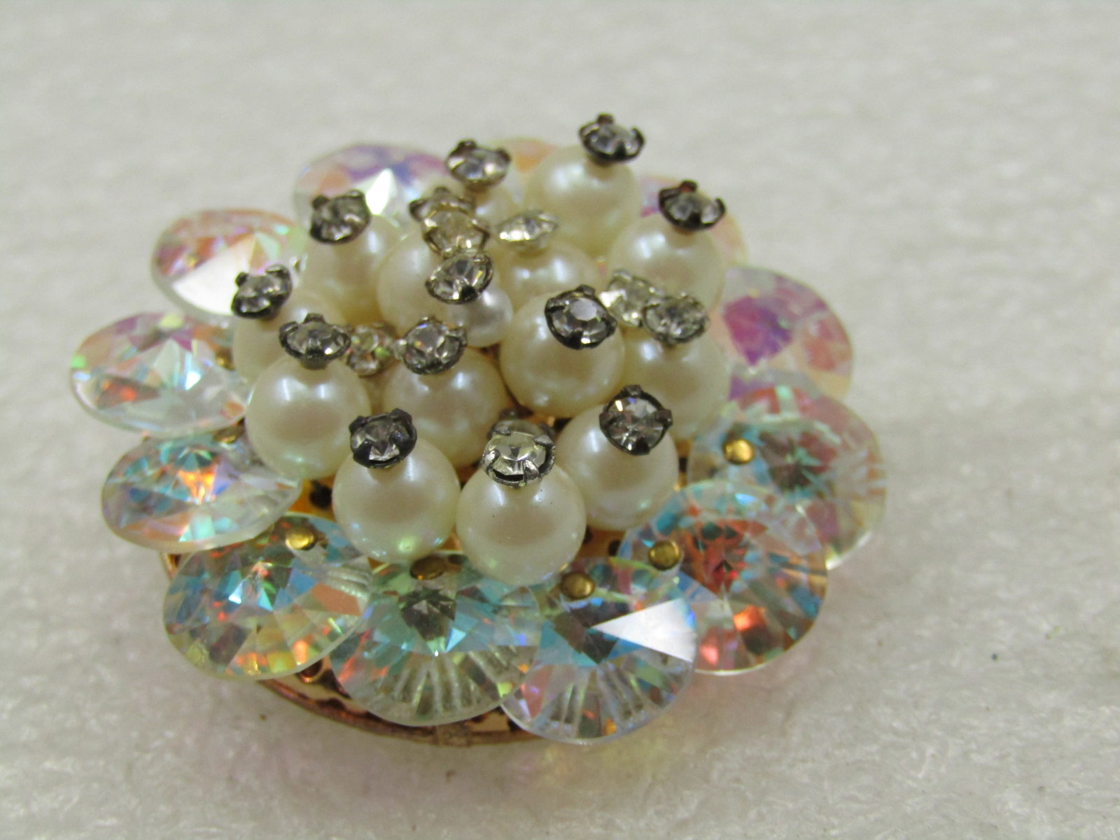 Vintage Rhinestone & Faux Pearl Round Brooch, Aurora Borealis, 1950's- 1960's: Vintage Rhinestone & Faux Pearl Round Brooch, Aurora Borealis, 1960's. This is 1.25" wide. This is a cluster brooch with round faceted and flat top rhinestones framing the broock and a cluster of faux