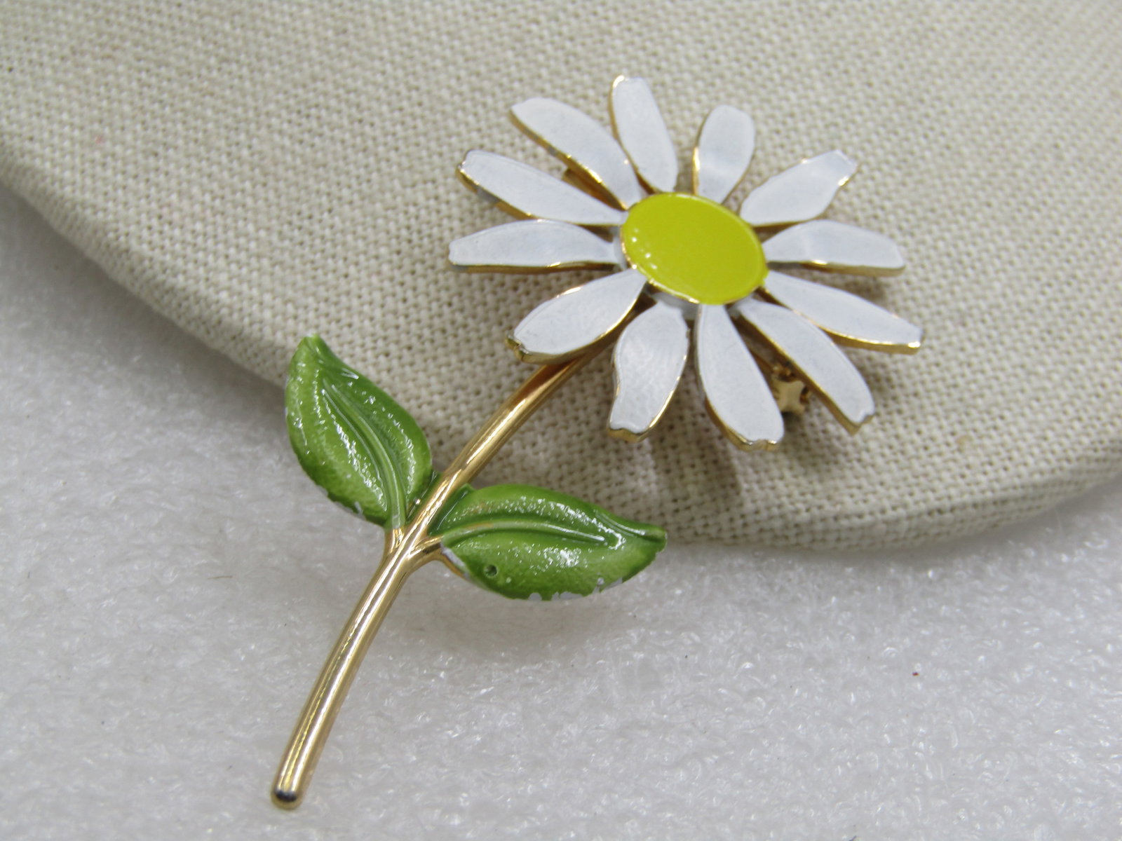 Vintage Enameled Daisy Brooch 1960's, 3": Vintage Enameled Daisy Brooch 1960's, 3" by 1-5/8". The blossom is white and yellow with a gold tone stem and green leaves. It is not signed by the maker. Very good condition. (W9.19o20.20.6 SS6880 AZ