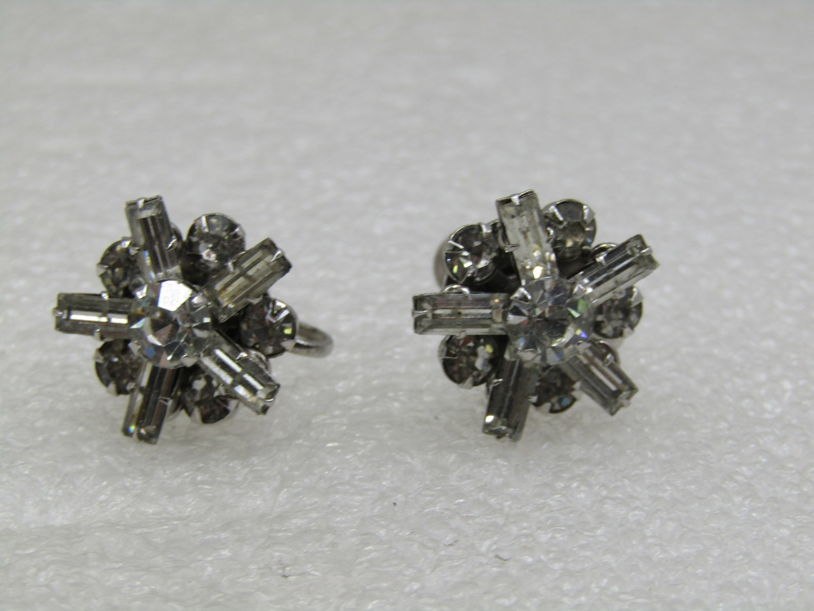Vintage Rhinestone Baguette Tiered Earrings, Screwback, 1950's-1960's: Vintage Rhinestone Baguette Tiered Earrings, Screwback, 1950's-1960's. These are appx. 3/4" round with a lower level of 3.5mm round clear stones with a 5 baguettes that are appx 5mm long and 3mm