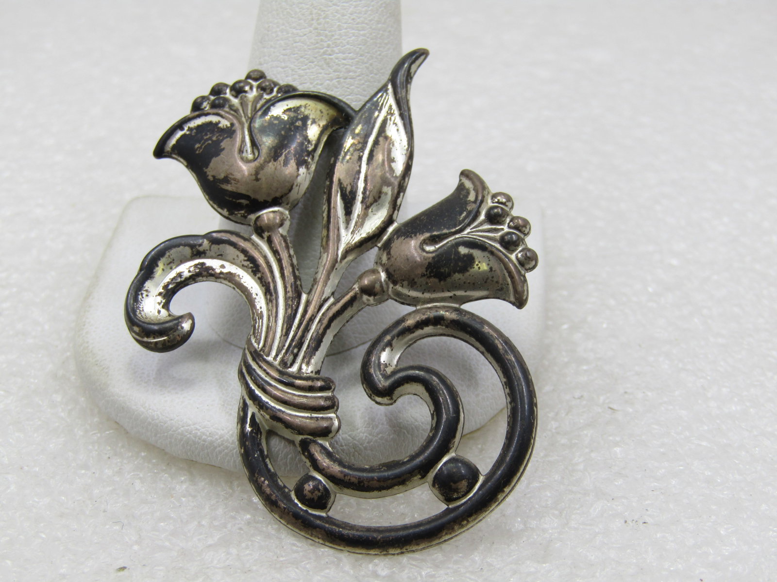 Vintage Sterling Floral Brooch, 1940's, 2.25" Signed SB: Vintage Sterling Floral Brooch, 1940's, 2.25" tall and 1.75" wide. Signed SB and marked sterling and tested. Weight is appx. 5.73 grams. It has two blossom and two leaves with a rounded/scrolled stem.