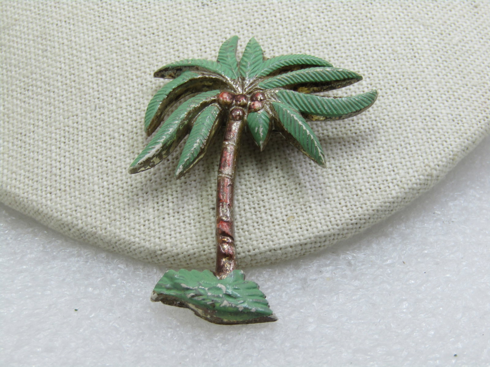 Vintage Painted Coconut Palm Tree Brooch, 1940's-1950's, 2.5": Vintage Painted Coconut Palm Tree Brooch, 1940's-1950's, 2.5" tall and 1-7/8" wide at the top. Enameled with green leaves and base and a copper and gold tone trunk and coconuts. . The back of the pin 