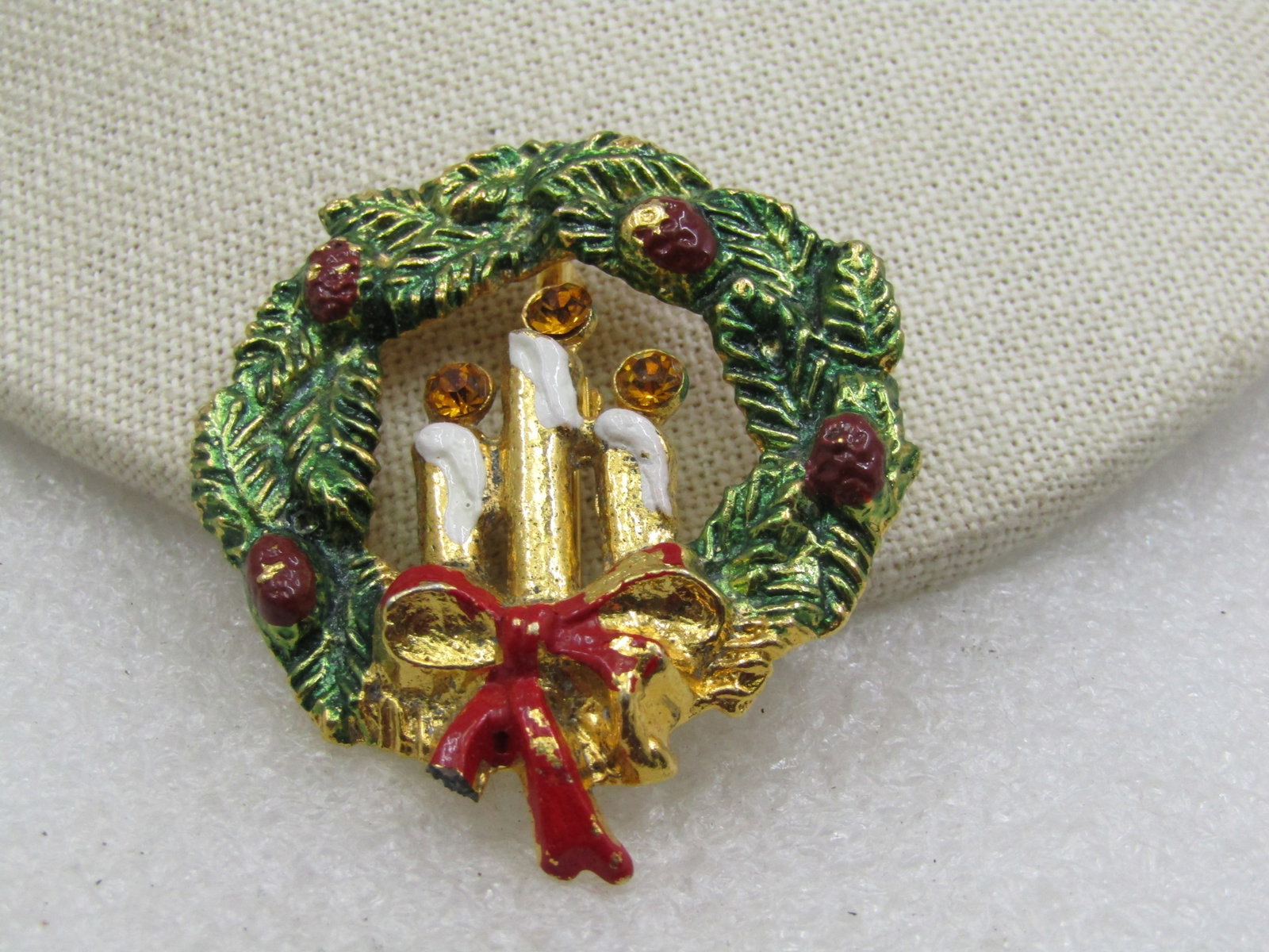 Vintage Christmas Pine & Candle Wreath Brooch, Enameled, 2": Vintage Christmas Pine & Candle Wreath Brooch, Enameled, 2". The pine is enameled in green with brown pincecones, a red bow and white dripping wax on the candles with yellow rhinestone flames. There