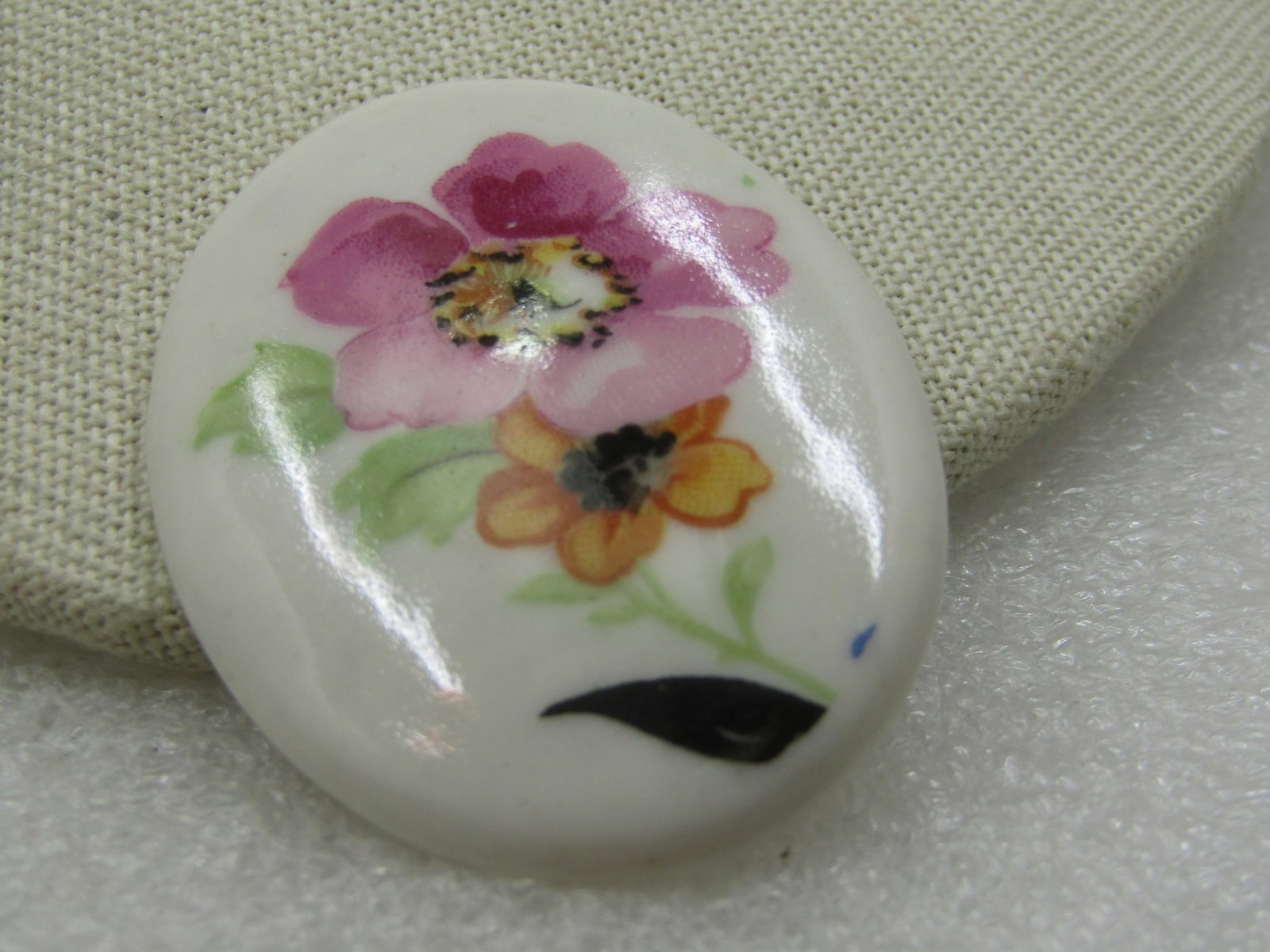 Vintage Adderly Floral Bone China Floral Floral Brooch, England, 1960's: Vintage Adderly Floral Bone China Floral Brooch, England. It is 1.75" wide and 1.25" tall with painted yellow 3-d pansy, rose, and purple blossom. The blossoms are sitting on a gold edged scrolled pla