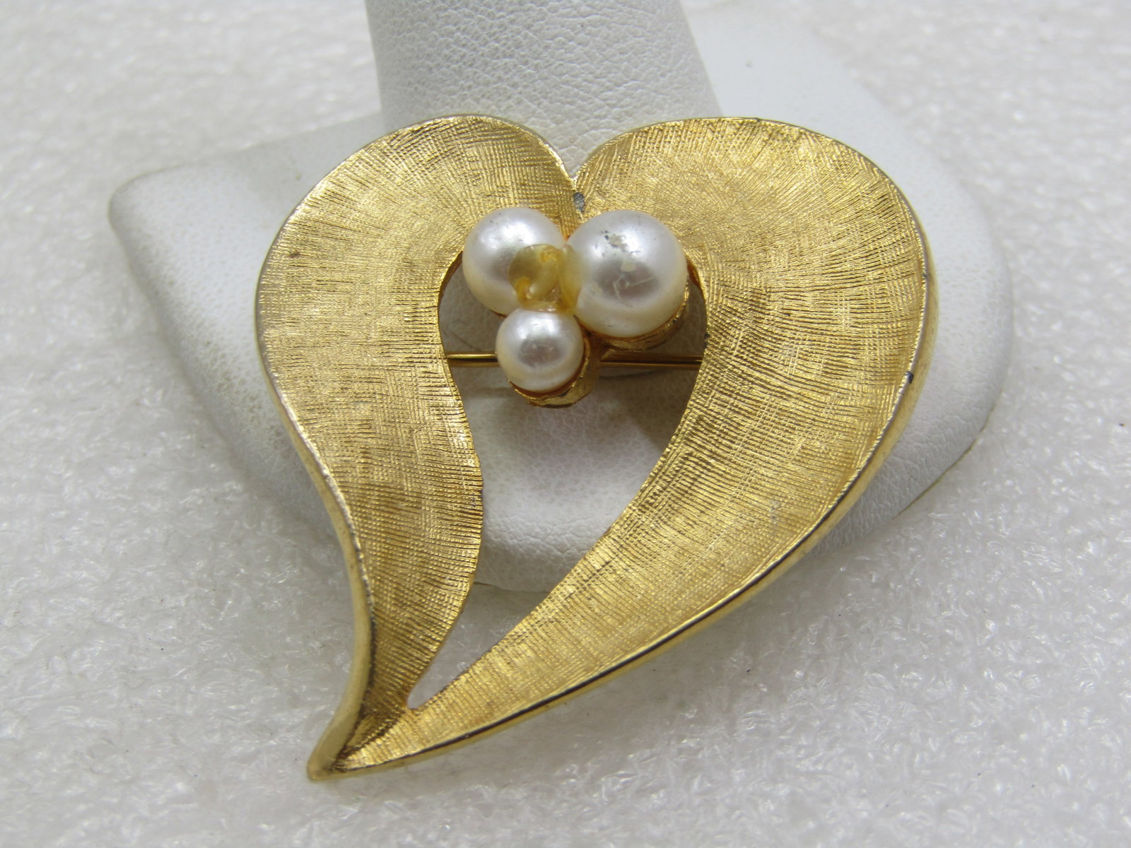 Vintage Heart & Faux Pearl Brooch, Offset Mod Design, 2": Vintage Heart & Faux Pearl Brooch, Offset Mod Design, 2" tall and 1.5" wide. Three faux pearls 5mm to 7mm in size. Gold tone. Open center. Not signed by the maker. Very good condition. Age is appx.