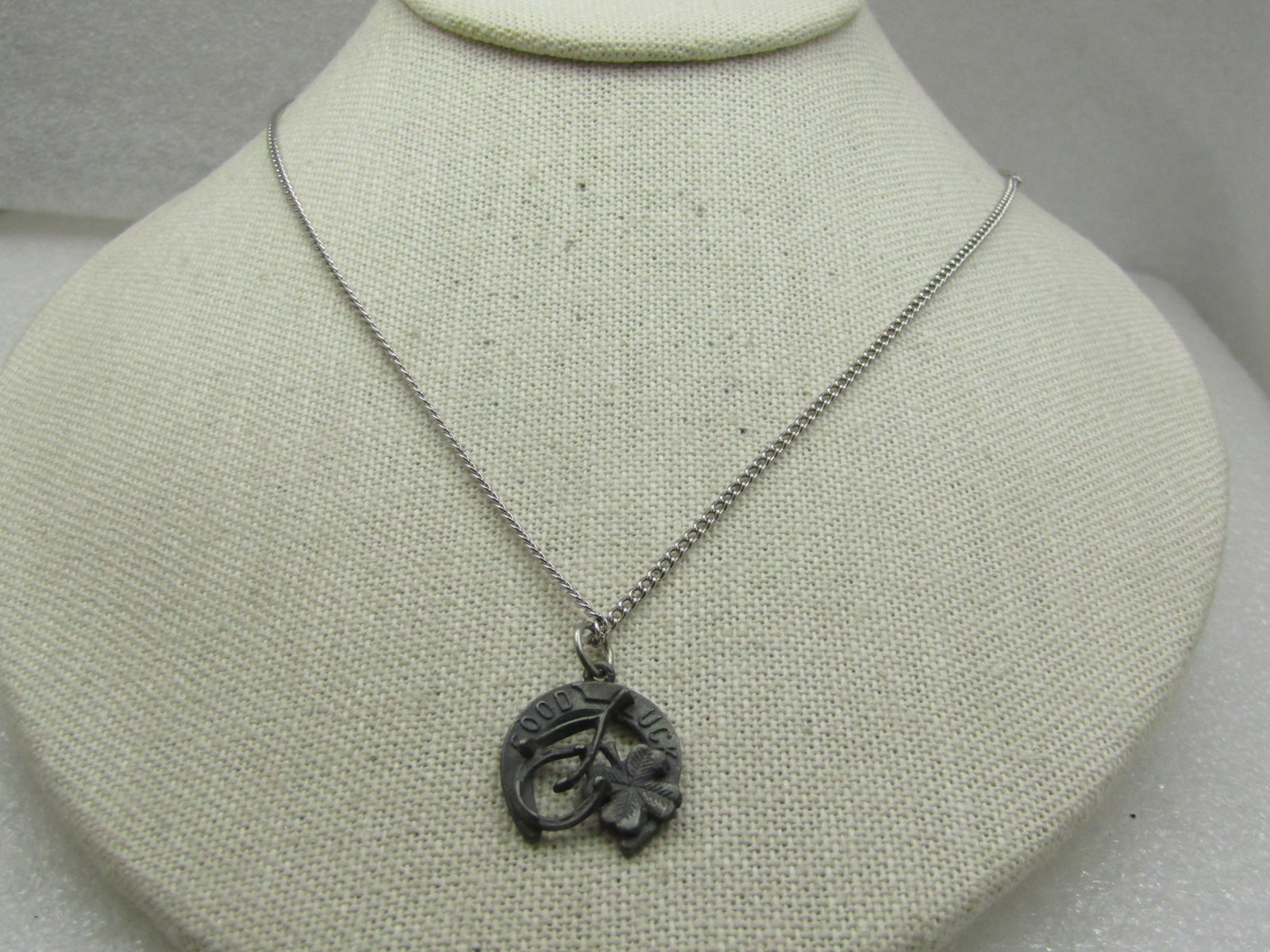 Vintage Good Luck Horseshoe , Clover Necklace, 18", 1950's-1960's: Vintage Good Luck Horseshoe , Clover Necklace, 18", 1950's-1960's. this has an 18" silver tone 1.5mm curv link chain with spring clasp. The pendant is a darker silver tone, possibly pewter with a a