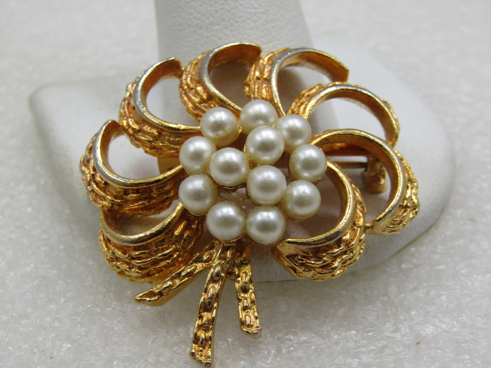 Vintage Spiral Brooch with Faux Pearl Cluster, 1960's, 1.5": Vintage Spiral Brooch with Faux Pearl Cluster, 1960's, 1.5". Gold tone with an open smooth and textured spiral design and three ribbon trails hanging below the pear cluster. Not signed by the maker. V