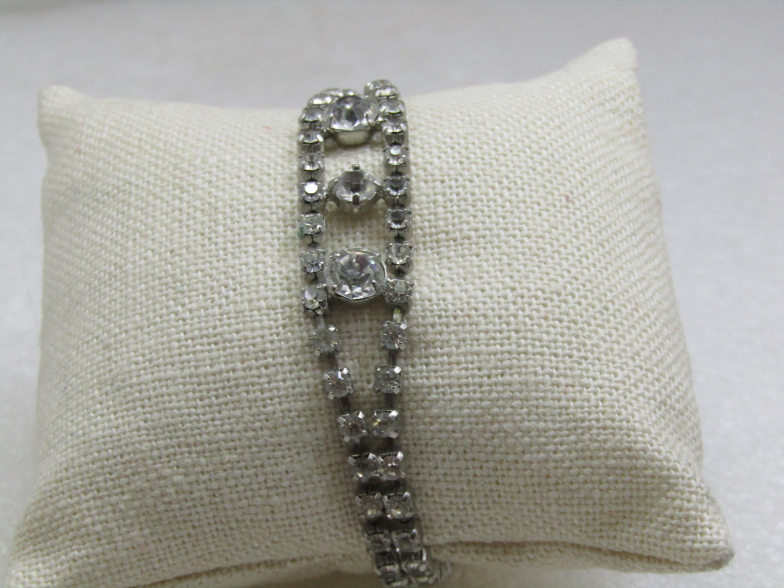 Vintage Clear Rhinestone Bracelet, 6.75" Art Deco Themed, 1960's: Vintage Clear Rhinestone Bracelet, 6.75" Art Deco Themed, 1960's. Double strand that separates in the center with three larger clear rhinestones set in the center at appx. 4.5mm in the center and