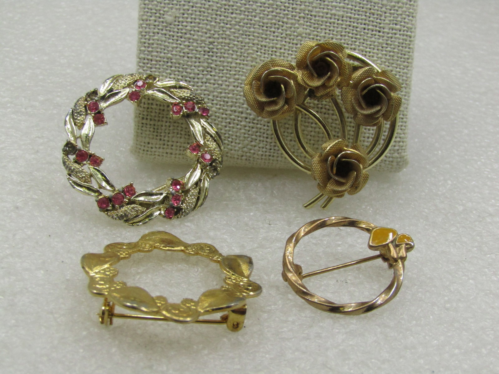 Vintage Four Circle Pin Lot, 1960's, Floral, Rhinestone: Vintage Four Circle Pin Lot, 1960's, Floral, Rhinestone. All are gold tone. A bouquest of 3-D Roses set on a double circle base. The brooch is appx. 1.5" tall and wide with the flowers extending beyon