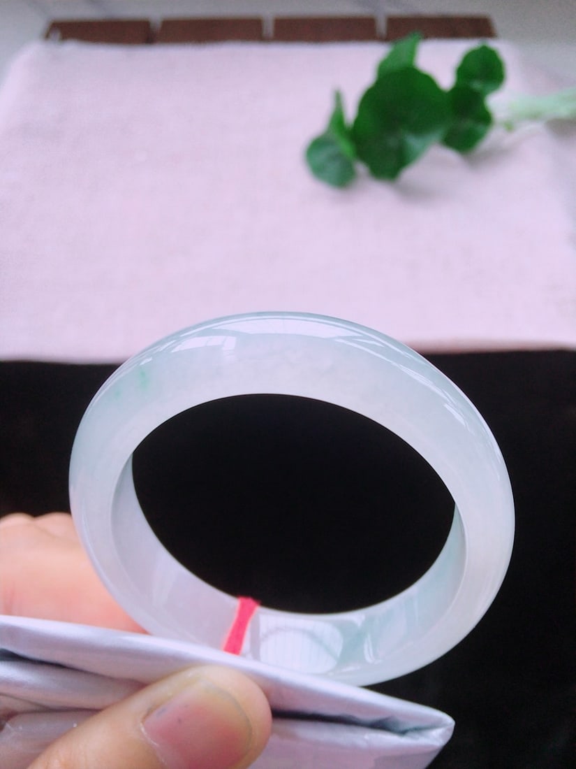 Jade Empress Bracelet: Title: Jade Empress Bracelet Description: This jade Guifei bracelet is renowned for its ice-type jade's watery and delicate texture, perfectly presenting an elegant charm. The design of the bracelet n