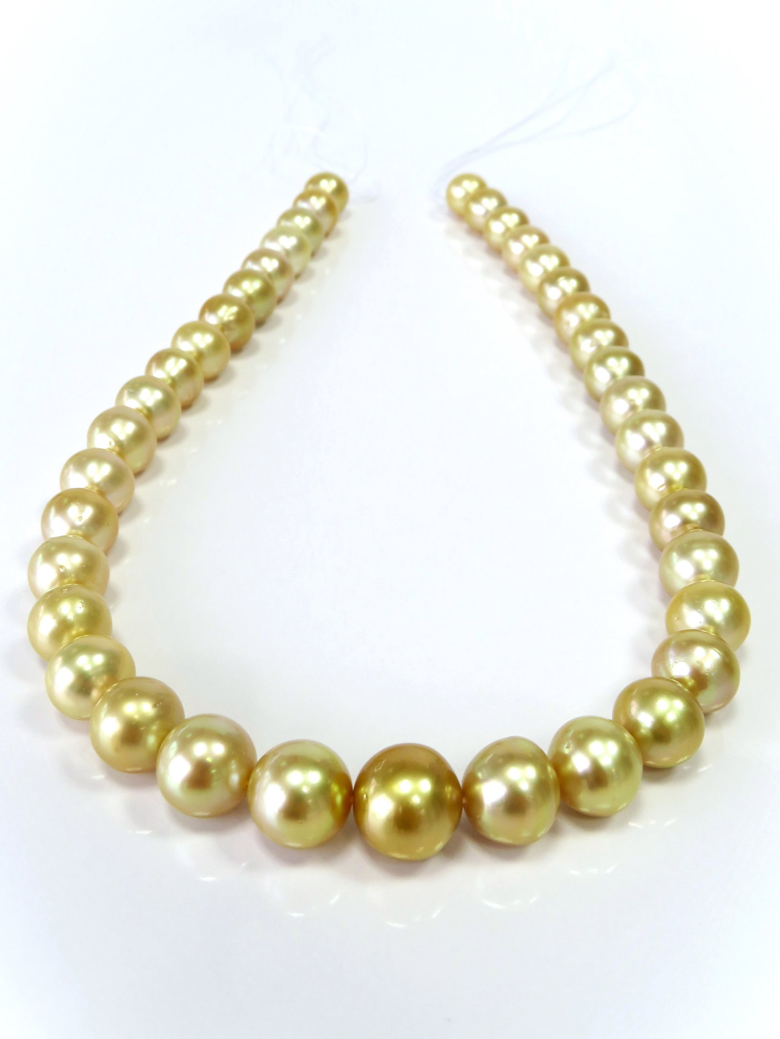 10-13mm Round/Button Golden South Sea Pearl Necklace Strand: Title: 10-13mm Round/Button Golden South Sea Pearl Necklace Strand Description:AA-Grade High luster Golden Round/Button, with minimal spots/blemishes, 39 pearl pieces, 18 inches long hand-knotted
