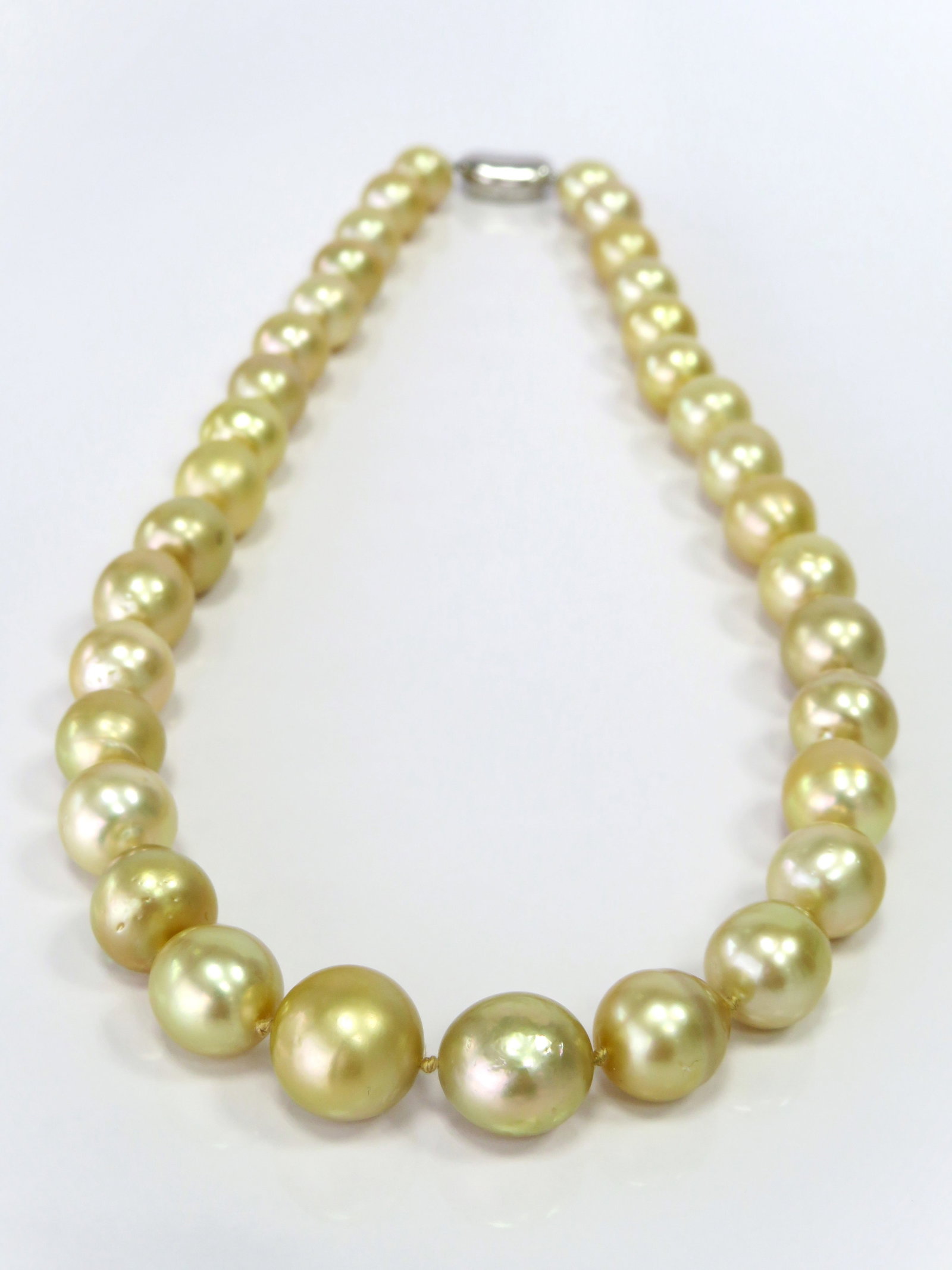 10-14mm Drop/Oval Golden South Sea Pearl Necklace: Title: 10-14mm Drop/Oval Golden South Sea Pearl Necklace Description:A-AA Grade High luster, Golden Oval/Drop, with minimal spots/blemishes, 34 pearl pieces, 18 inches long hand-knotted with 925
