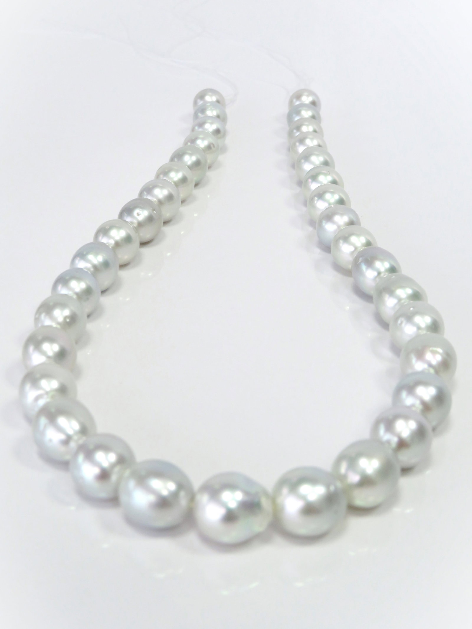 10-12mm Drop/Oval White South Sea Pearl Necklace Strand: Title: 10-12mm Drop/Oval White South Sea Pearl Necklace Strand Description:A/B-Grade High luster White Drop/Oval, with some spots/blemishes, 35 pearl pieces, 18 inches long hand-knotted with 14k YG fi