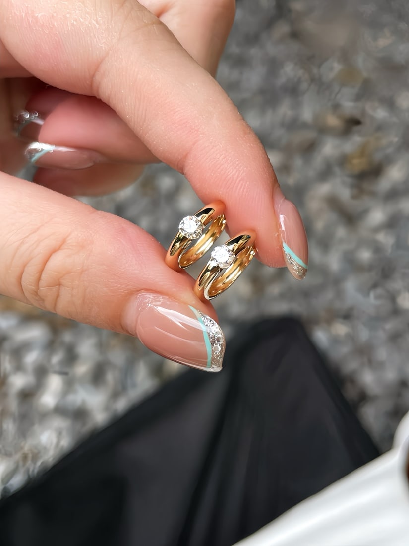 A pair of 18K gold diamond earrings.: Title: A pair of 18K gold diamond earrings. Description: This 18K gold diamond stud earrings feature a sleek and minimalist design style, injecting a unique and charming personality. The polished