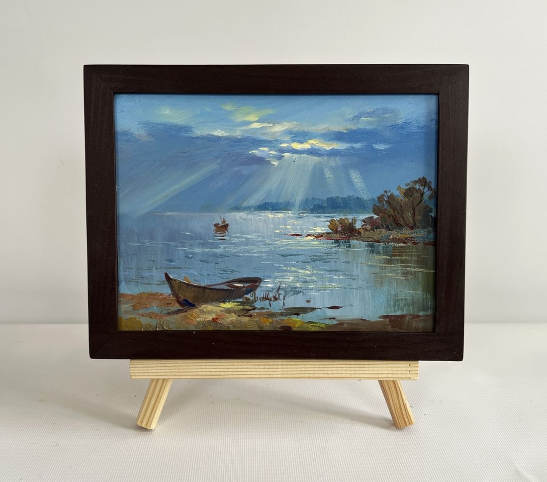 Oil painting Rays of sun through the clouds Yuriy Suprunchuk: NoAAA4419The painting "Rays of Sun Through the Clouds" beautifully captures the serene and ethereal moment when sunlight breaks through a dense canopy of clouds, casting golden beams onto the calm wat