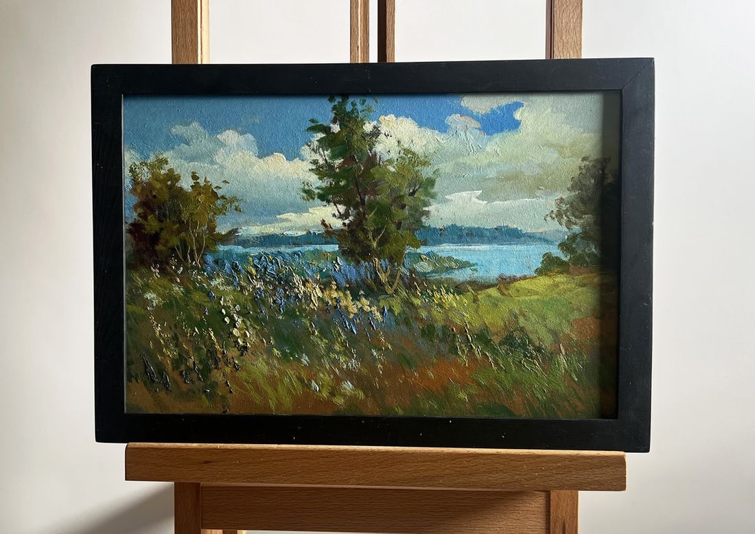 Oil painting Flower field and river Yuriy Suprunchuk: NoAAA4187The painting titled "Flower field and river" beautifully captures the harmony between land, water, and sky, offering a scene of tranquility and natural splendor. The foreground is filled with