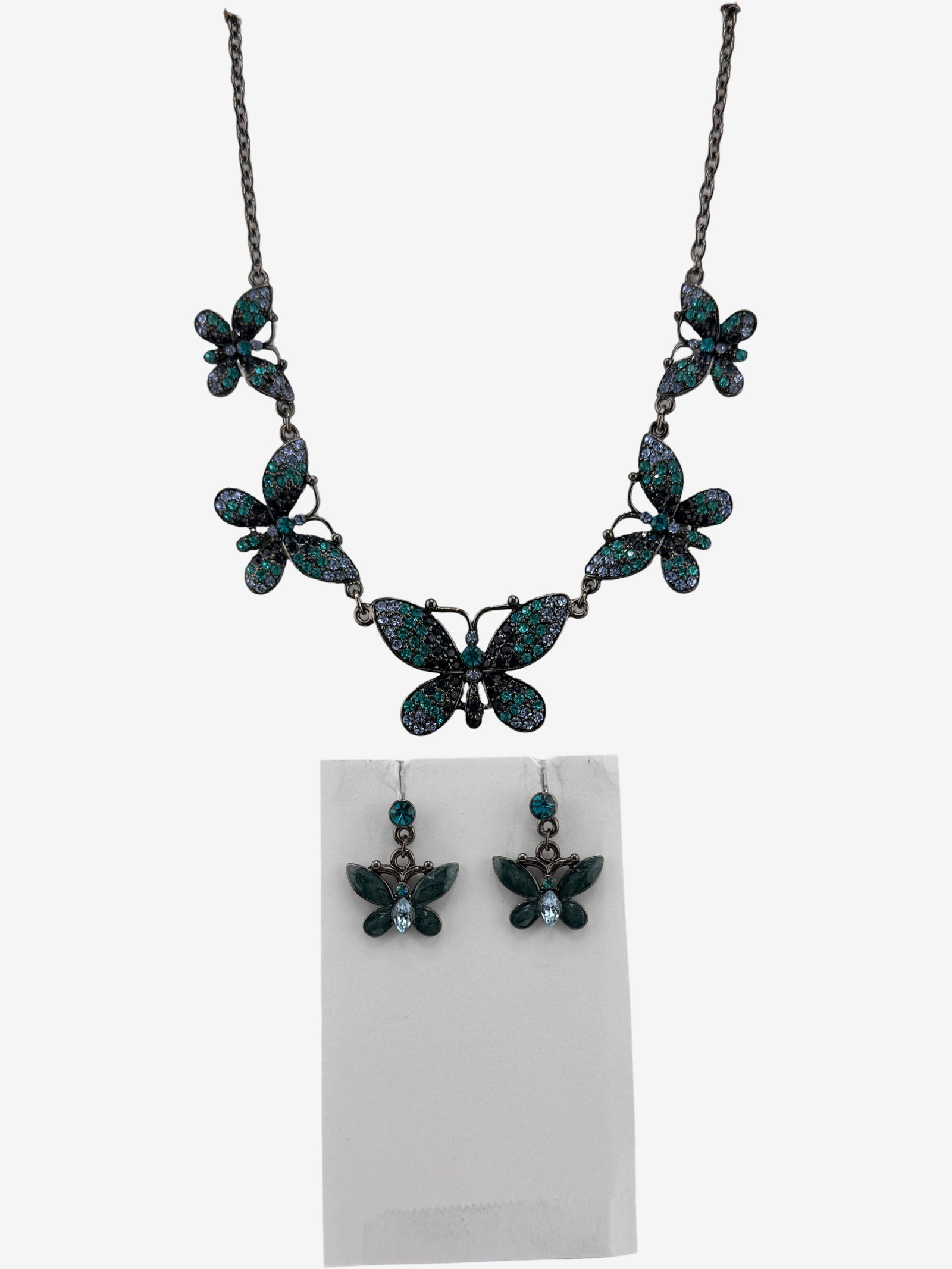 Butterfly Motif Necklace and Earring Set: A whimsical matching necklace and earring set featuring a butterfly motif. The necklace showcases five graduating butterfly elements, each adorned with faceted blue and green stones, possibly glass or