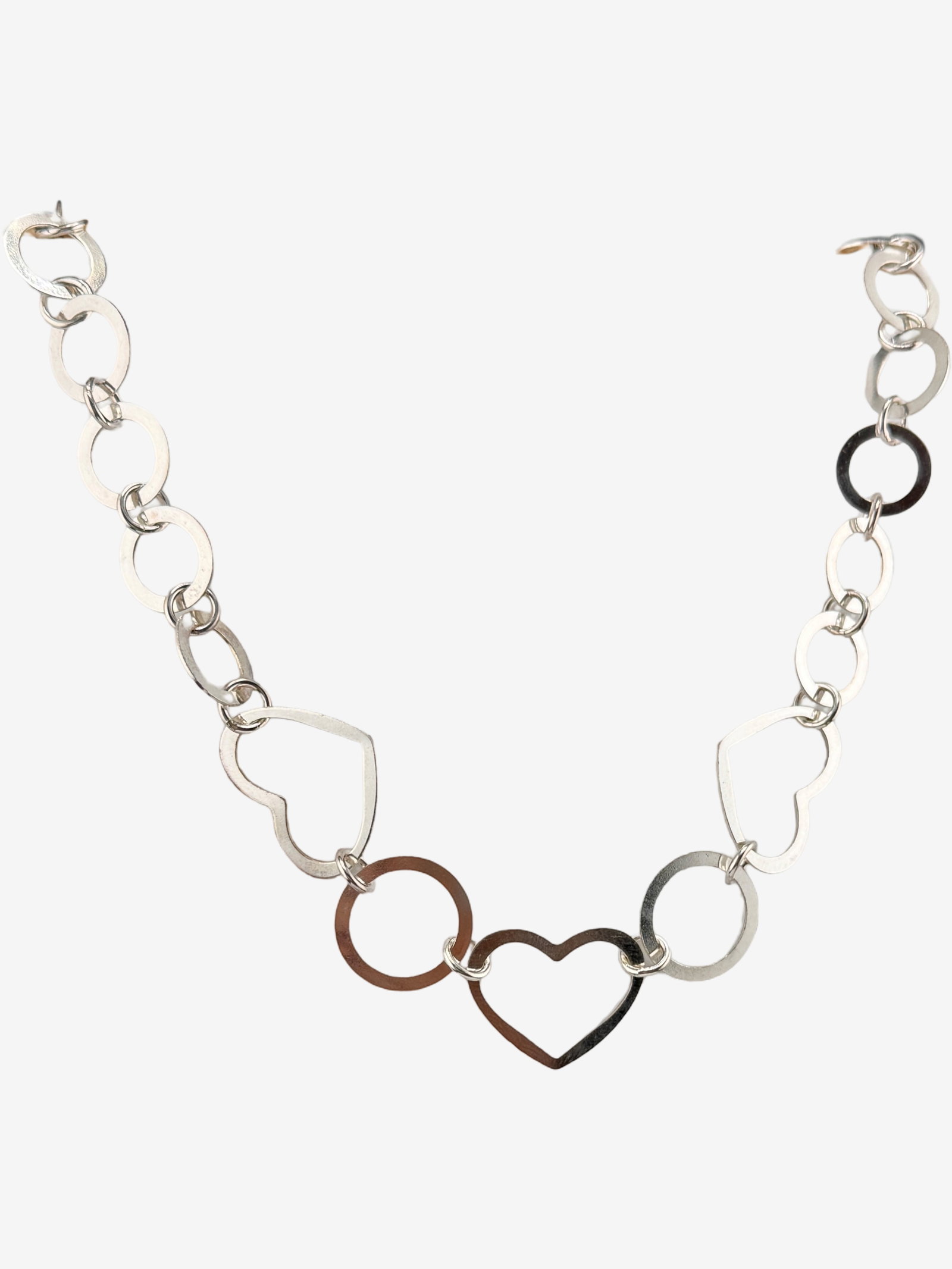 Sterling Silver Heart and Circle Link Necklace 18.10g: A contemporary sterling silver necklace featuring alternating heart and circular links. The necklace has a polished finish and secures with a lobster clasp. The chain includes a small spherical charm