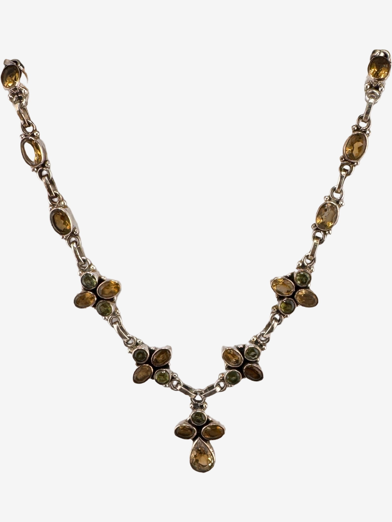 Sterling Silver and Multi-Gemstone Necklace 26.28g (incl. stones): This elegant necklace features a series of oval and round-faceted gemstones set within sterling silver links. The gemstones appear to be citrine and peridot, offering a lovely contrast of warm yellow