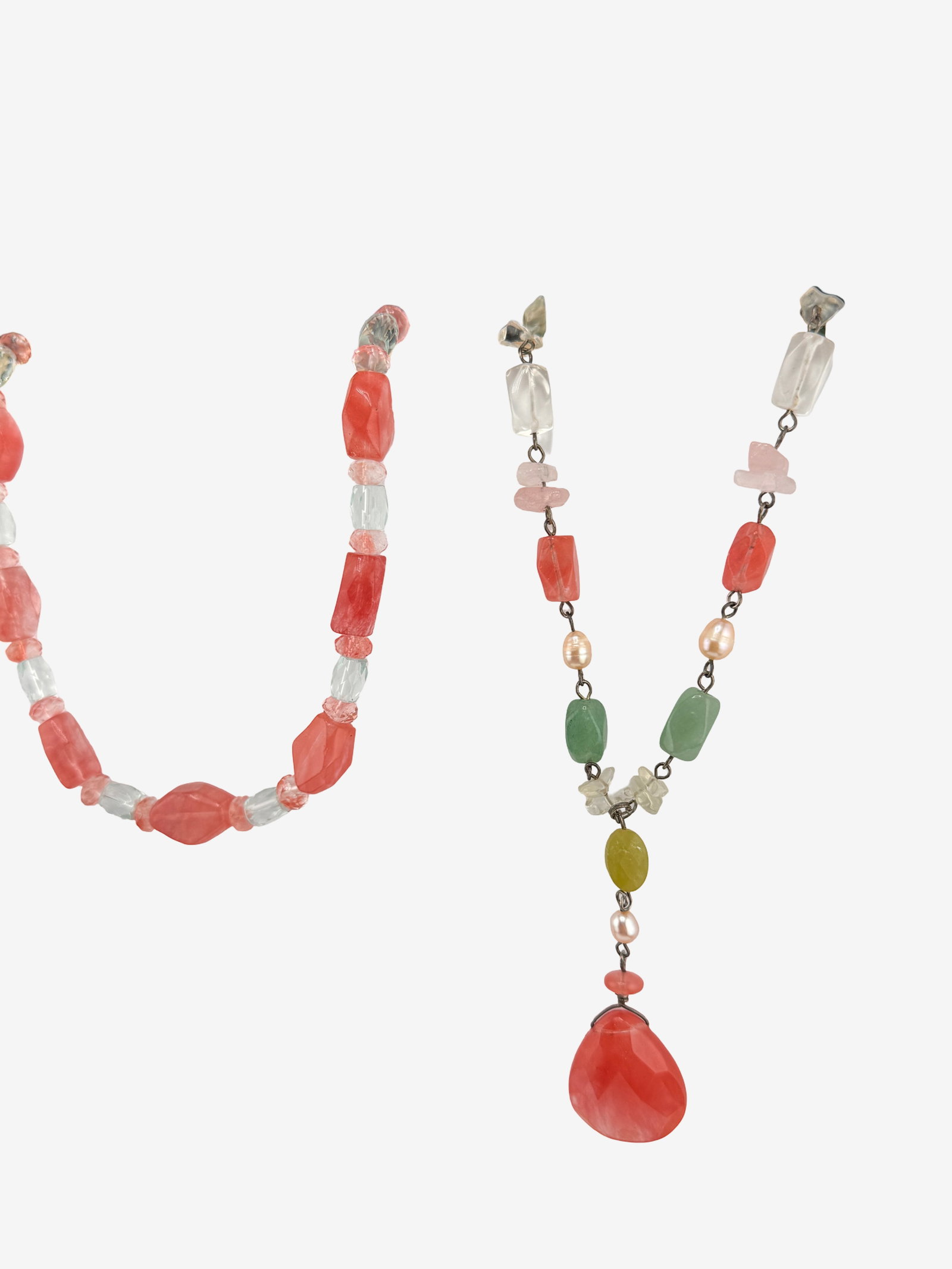 Two Colorful Beaded Necklaces (925): Two vibrant beaded necklaces, meticulously crafted with an assortment of natural stones and glass beads. The necklaces feature irregularly shaped, tumbled, and faceted beads in shades of opaque red/pi
