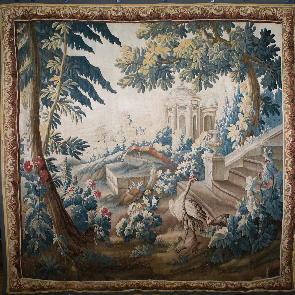 Large French verdure forest Hand weaved 18th. Aubusson: This tapestry depicts a peaceful forest scene and is called a "Verdure" tapestry because it showcases lush foliage. These types of tapestries were highly valued for their beauty in the 17th century. T