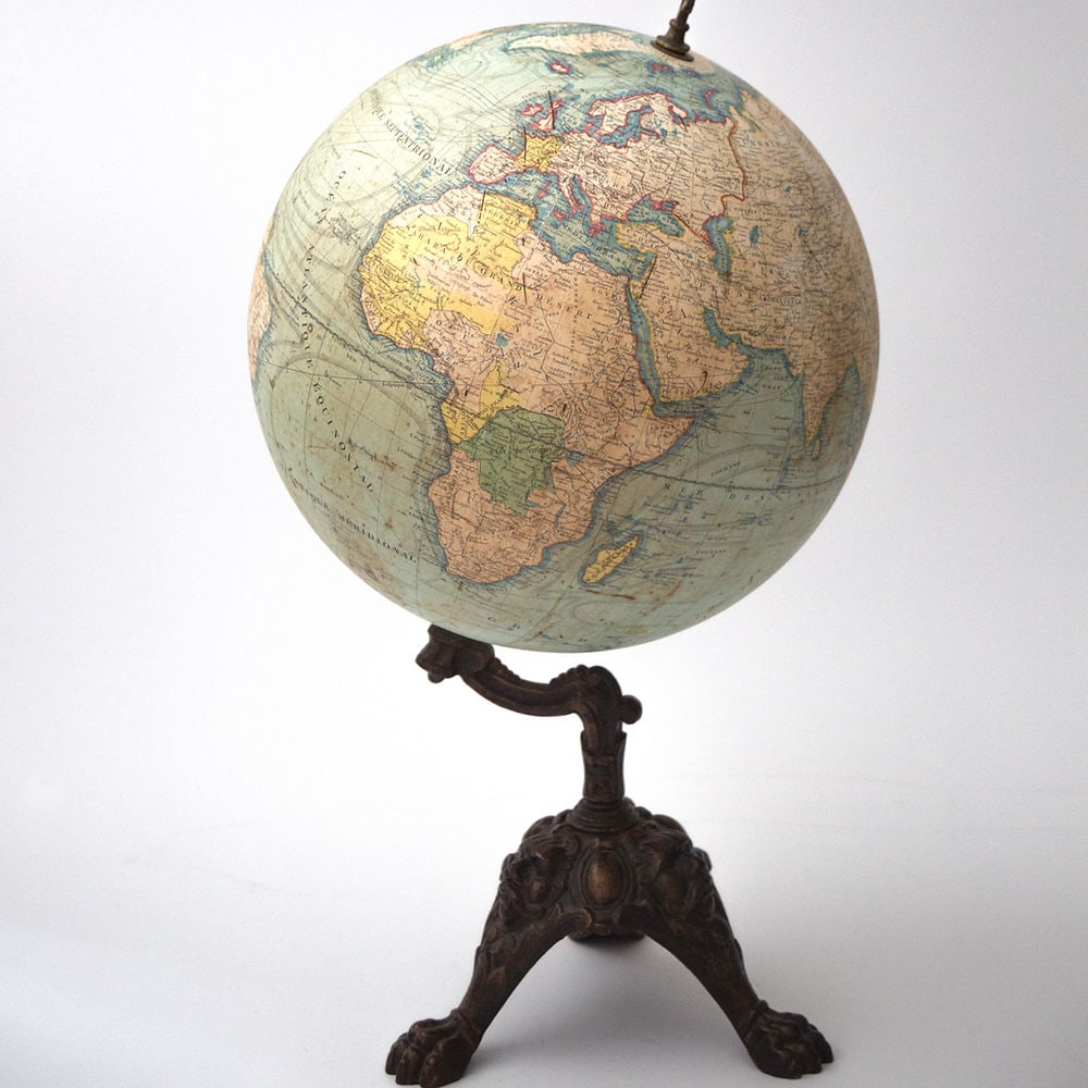 LEBEGUE 14" FRENCH TERRESTRIAL GLOBE ANTIQUE: Lebegue terrestrial globe with cast iron base featuring African , Indian and asian stereotypical face on the arm , usualy it just feature a face in the manner of Violet Leduc . This 12 inches French g