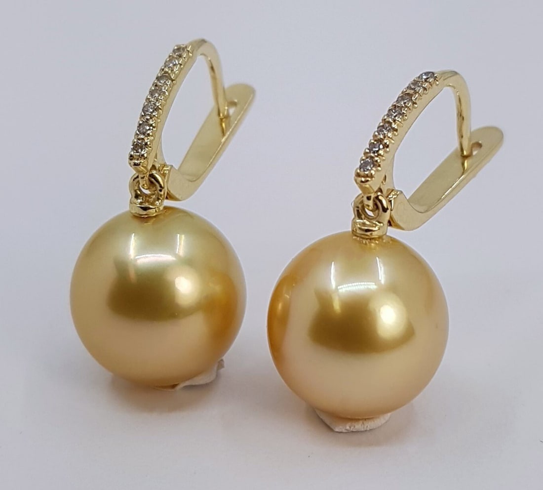 Earrings - 14 kt. Yellow gold - 0.11ct. tw. - 11x12mm: Title: Earrings - 14 kt. Yellow gold - 0.11ct. tw. - 11x12mm Description: Produced by the gold-lipped Pinctada Maxima Oyster in the warm waters of Indonesia, these pearls have a natural magnificent de