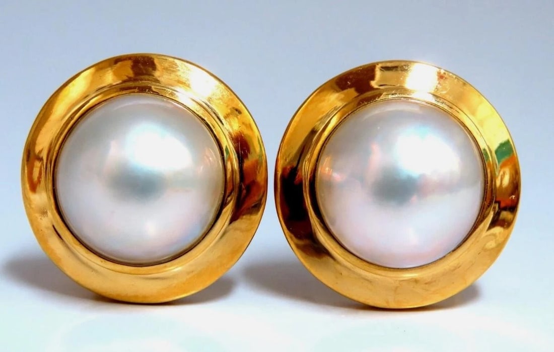 12mm Mabe Pearls Earrings 18kt Gold**: Title: 12mm Mabe Pearls Earrings 18kt Gold** Description: 12mm Mabe Pearls Earrings 18kt Gold** $3,100.00 PRODUCT DESCRIPTION Mabe Pearl clip earrings. 12mm Pearl Excellent AAA luster and Sheen silver