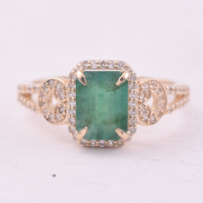 1.73 Ct Octagon Emerald 9K Gold Ring: 1.73 Total Carat Emerald 9K Gold Ring Specifications: Total Weight 2.127 g Center Gemstone Emerald Gemstone Carat Weight 1.41 Carats Gemstone Measurements 8X6 mm Additional Gemstones White Sapphire Ad
