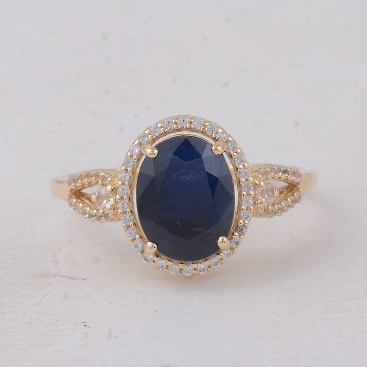 4.10 Ct Oval Blue Sapphire 9K Gold Ring: 4.10 Total Carat Blue Sapphire 9K Gold Ring Specifications: Total Weight 2.839 g Center Gemstone Blue Sapphire Gemstone Carat Weight 3.82 Carats Gemstone Measurements 9.30X7.30X6.10 mm Additional