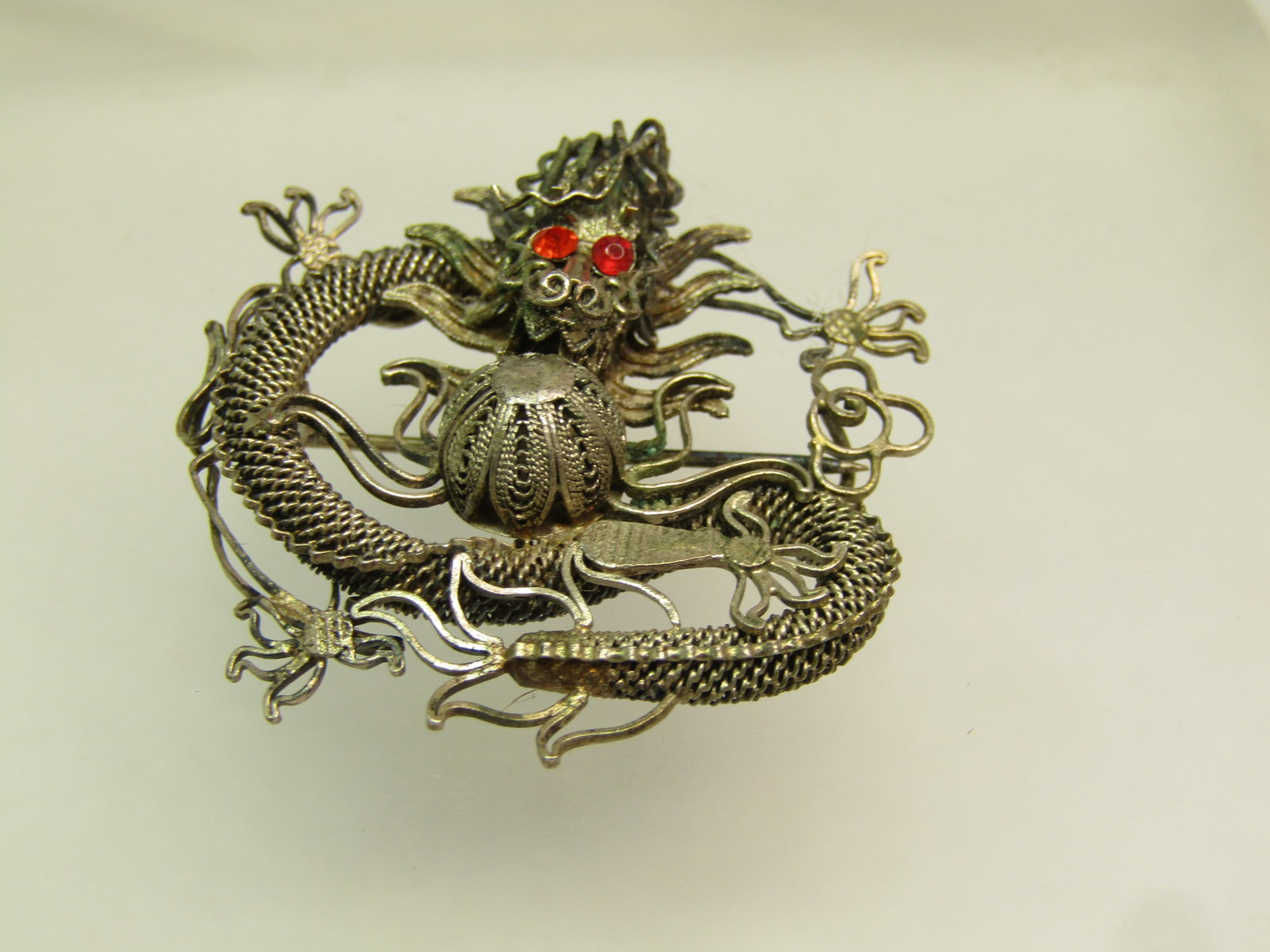 Antique Filigree Dragon Brooch, Rhinestone Eyes, Chinese Import, Early 1900's.: Title:Antique Filigree Dragon Brooch, Rhinestone Eyes, Chinese Import, Early 1900's. Description:Antique Filigree Dragon Brooch, Rhinestone Eyes, Chinese Import, Early 1900's. This is silver tone