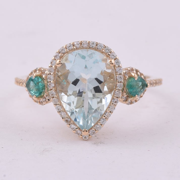 3.09 Ct Pear Aquamarine 9K Gold Ring: 3.09 Total Carat Aquamarine 9K Gold Ring Specifications: Total Weight 2.451 g Center Gemstone Aquamarine Gemstone Carat Weight 2.52 Carats Gemstone Measurements 11X8X5.70 mm Additional Gemstones
