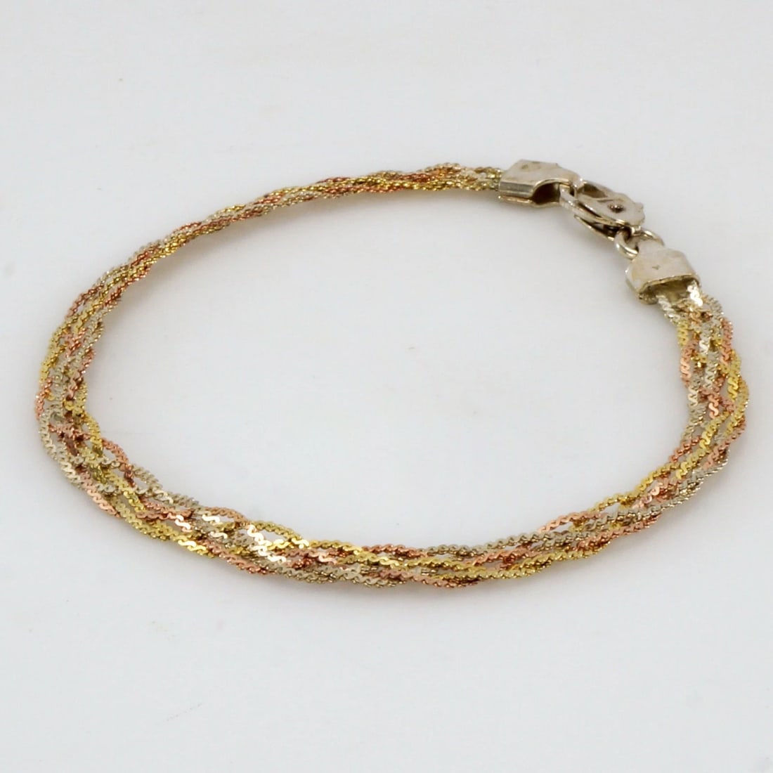 Vintage Italian Tri-color Sterling Bracelet: Title:Vintage Italian Tri-color Sterling Bracelet Size:7 ½ in (19.0 cm) long x 3 1/16 in (2.7 cm) wide x .04 in (1 mm) thick. Description:An Italian-made multi-strand, braided bracelet featurin