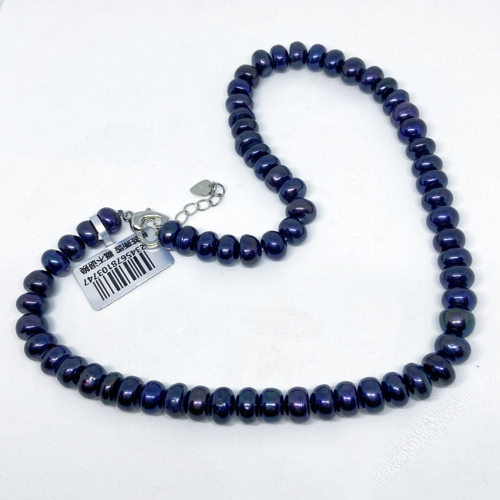 High Luster Shell-Pearl Necklace: Title: High Luster Shell-Pearl Necklace Description:These shell-pearls have a natural beautiful peacock blue black colour with shimmering hues and a rich luxurious luster. Date/Period: 20th Century