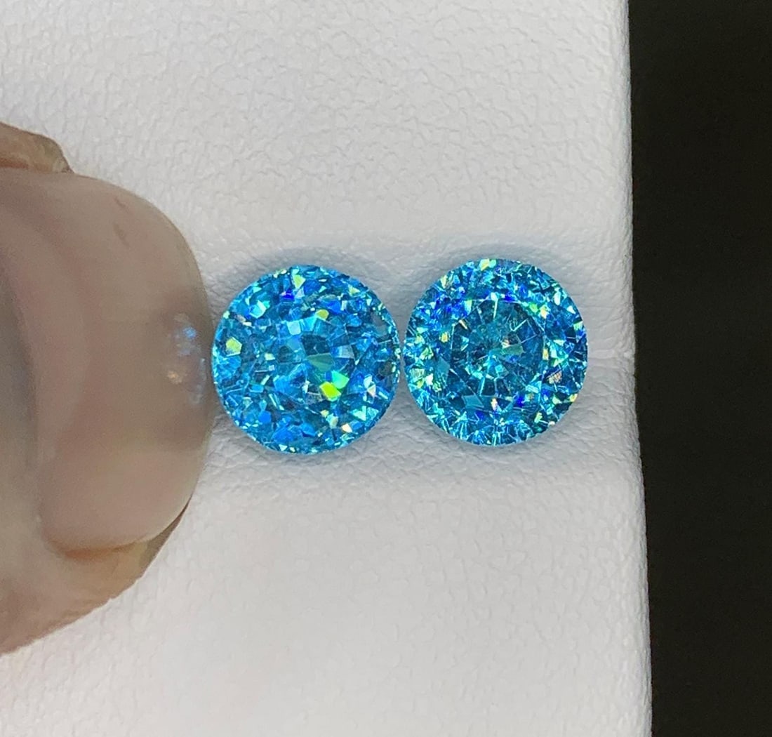Cambodian Blue Zircon Pair Gemstone : Round Cut: Highlights Supplies for making crafts Materials: Gemstone: Zircon Cambodian Blue Zircon Pair Gemstone Elevate your jewelry collection with the exquisite beauty of this Natural Full Fire & Sparkly