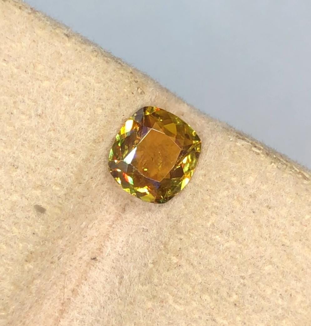 Rainbow Fire Natural Sphene Cushion Cut Loose Gemstone For Ring And Jewellery - 0.70 Carat: Highlights Supplies for making crafts Materials: Gemstone: Sphene Carat weight: 0.70 This 0.70 carat natural rainbow fire dazzling Sphene loose gemstone is translucent and has a fire-like hue. The gem