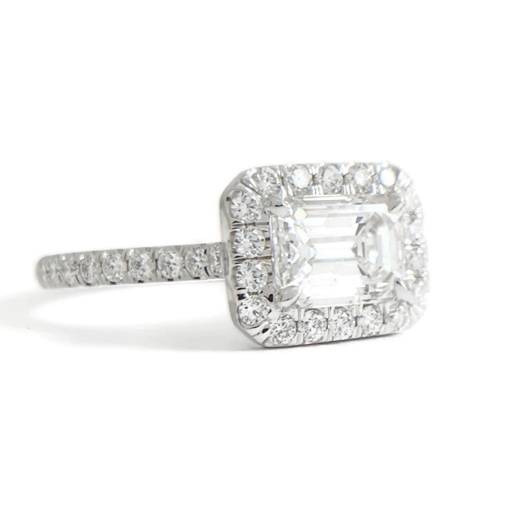 GIA Emerald Cut East West Halo Diamond Engagement Ring 18K White Gold 1.53 CTW: GIA Emerald Cut East West Halo Diamond Engagement Ring 18K White Gold 1.53 CTW This is a gorgeous diamond engagement ring! Please let us know if you have any questions! Diamonds: 1.53 ctw; 1 emerald
