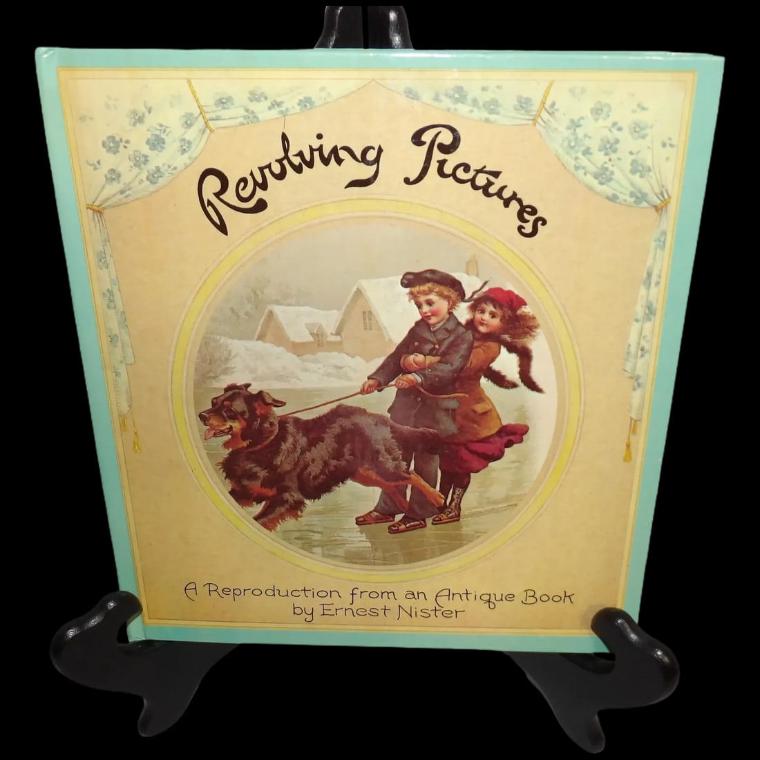 Revolving Pictures Children's Book by Ernest Nister, c. 1979: Is reprinted from the original "Revolving Pictures" first published in 1892 by Ernest Nister. It is a hardback collection of poems with beautiful illustrations. Gently pull the ribbon on the wheel to