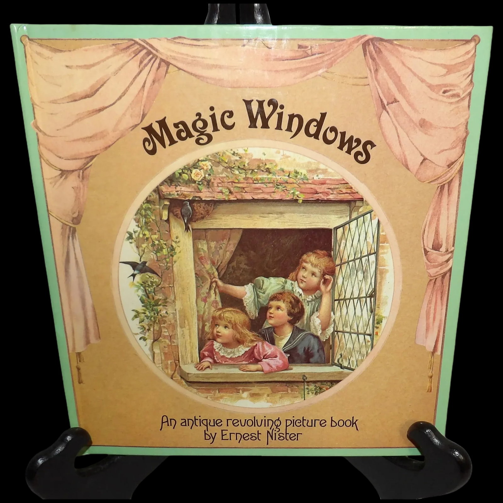 Magic Windows Revolving Picture Children's Book, c.1980: This is a reprint from the original "In Wonderland" first published in 1895 by Ernest Nister. It is a hardback collection of poems with beautiful illustrations. Gently pull the ribbon on the wheel to
