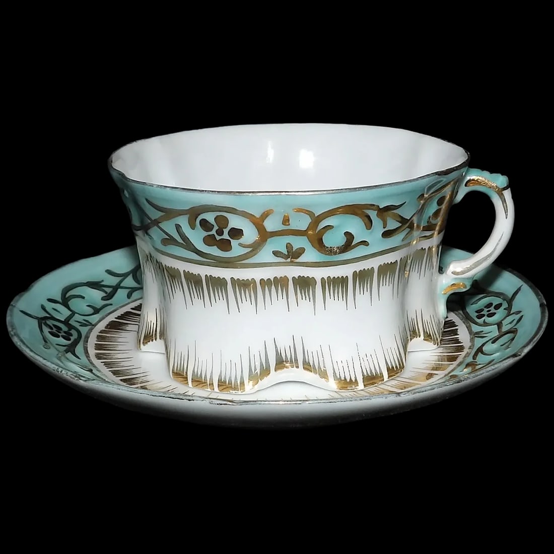 Antique Gold Gilded White & Blue Porcelain Cup and Saucer: This Antique Gold Gilded White& Blue Porcelain Cup and Saucer is a stunning example of the Victorian era. It is in excellent condition. No loss of color, chips, flea bites, but does have some minor