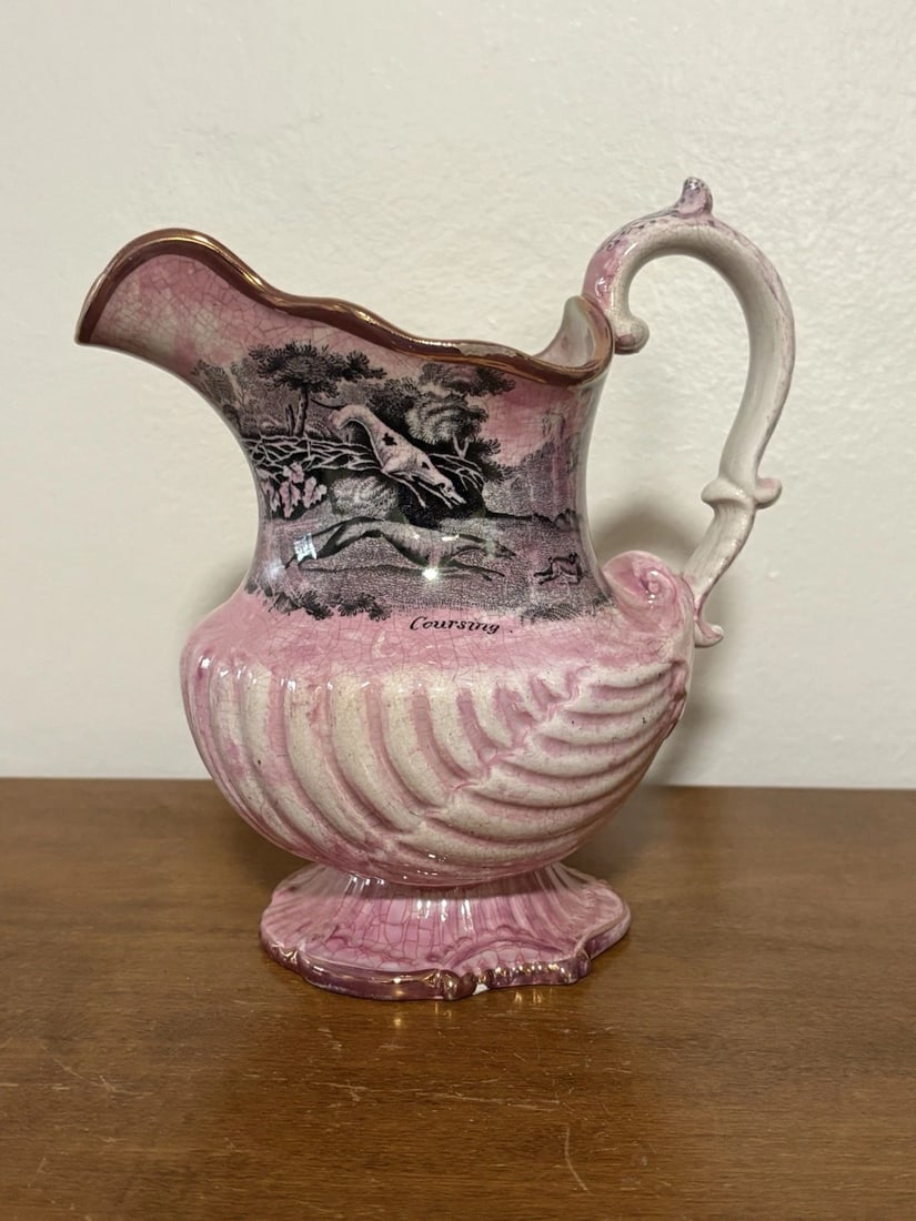 Pink Lustre Staffordshire Pitcher W/ Hunting Scene: It is 7 1/8" high and dates around the 1830's. It has a little paint wear on the top rim and a tiny flake on the bottom rim. Otherwise it has no other issues Shipping: Domestic: Flat-rate of $15.00 to