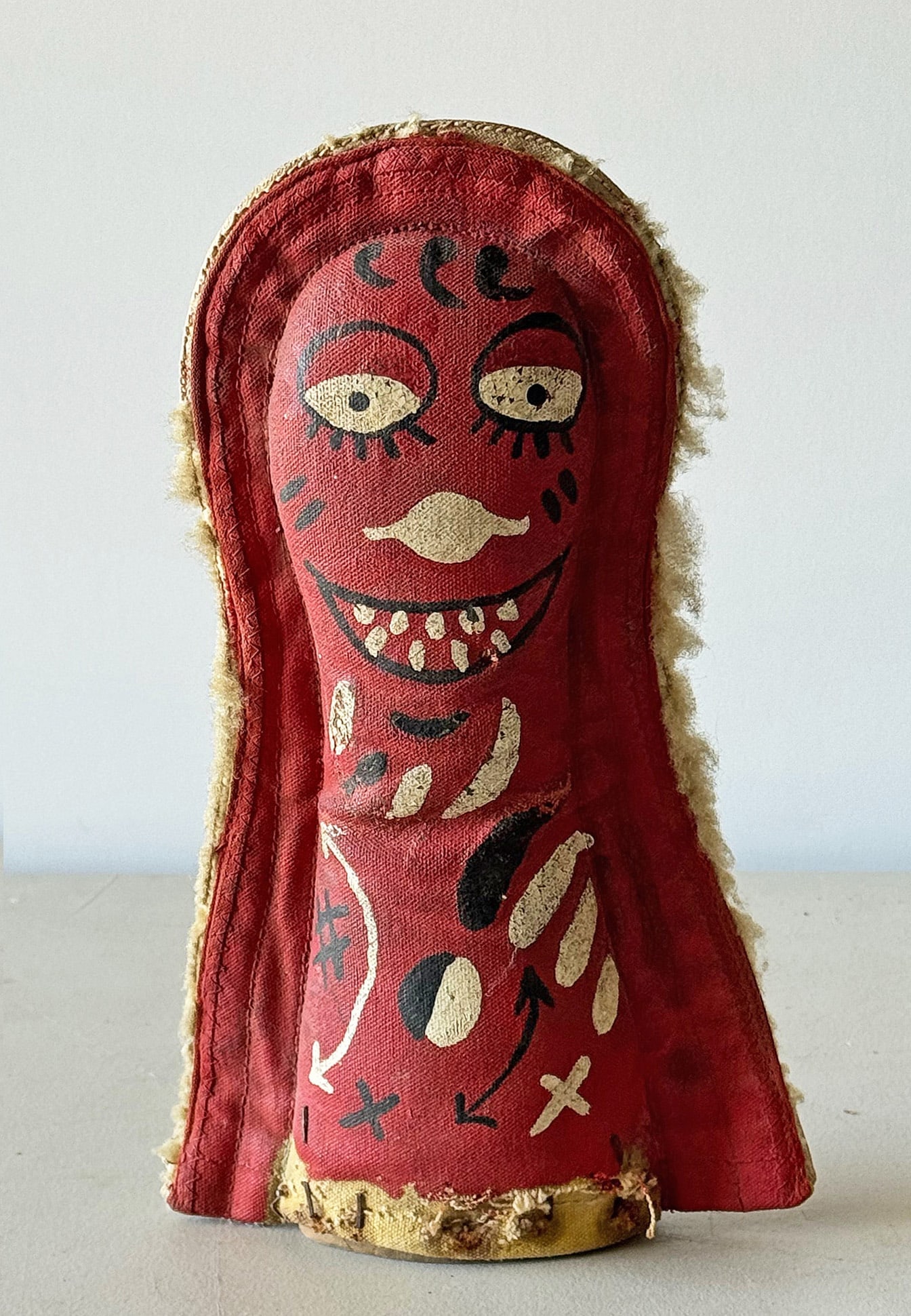 Vintage Carnival Clown Knock Down Doll: A red painted carnival knockdown or punk. Hand painted over a heavy canvas featuring a smiling face tempting the player to hit them with a ball to win a prize. Double sided with a white painted backgr