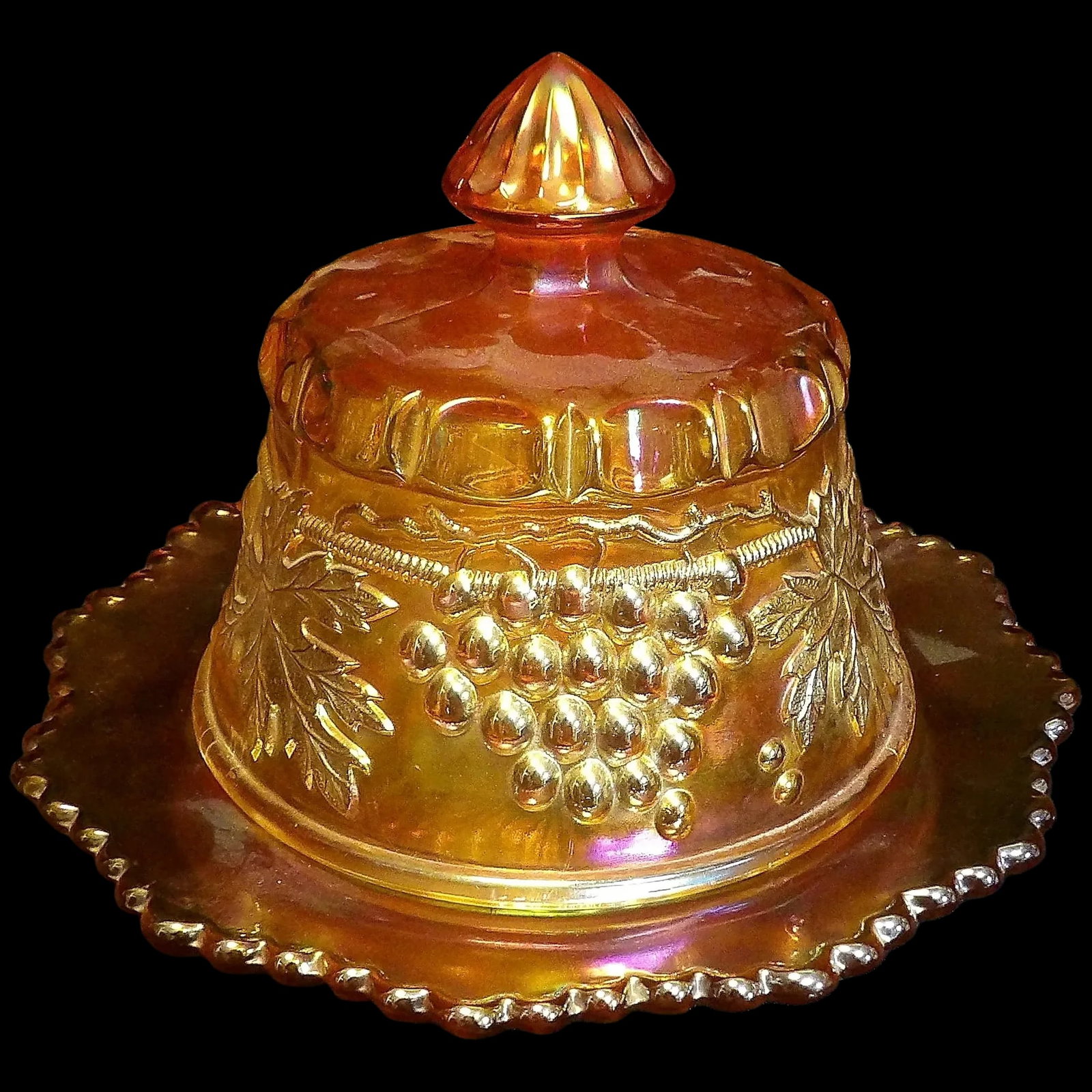 Antique Northwood Grape and Cable Butter Dish: This Antique Northwood Grape and Cable Butter Dish is in excellent condition. NO chips, stains or flea bites. It measures Width: 7 1/2 in X Height: 6 in. It is Pressed Carnival Glass. If you collect