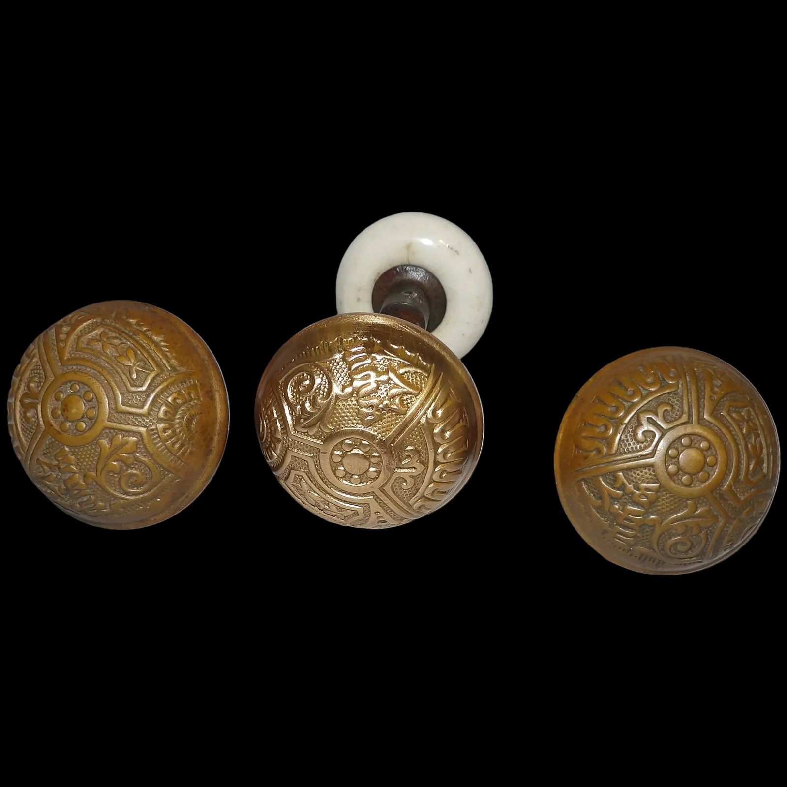 Antique Brass Wide Base Corbin Ceylon & Porcelain Doorknobs: The 3 Antique Brass Wide Base Corbin Ceylon & Porcelain Doorknobs are in excellent condition. Easily cleaned to bright finish as shown. They measure 2 1/4" in diameter. The Porcelain knob is in excell