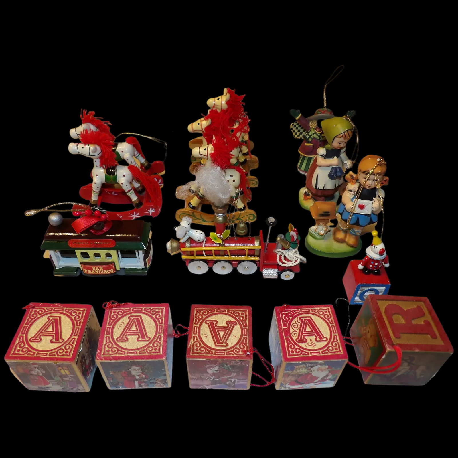 Collection of 1990's Christmas Ornaments: This Collection of 1990's Christmas Ornaments is in excellent condition. It included on Dept. 56 block, 4 Santa blocks, 5 rocking horses, 3 figurines, 1 fire engine, 1 street car, 1 small block- a tot
