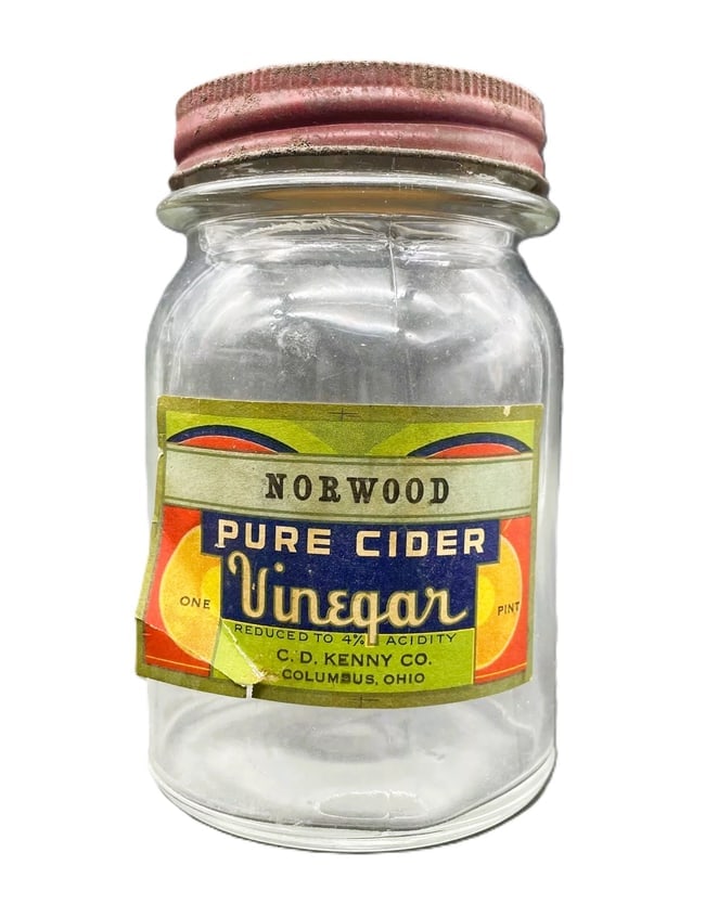 Vintage NORWOOD PURE CIDER VINEGAR GLASS JAR" C.D. Kenny Co. Baltimore Maryland: Date/Period: unknown Dimension: Approx. 5" tall x 3" diameter Material: glass Additional Information: Add a touch of vintage charm to your kitchen or collection with this clear glass jar from