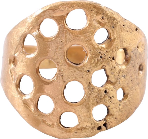 VIKING WARRIOR'S SHIELD RING, 10TH CENTURY AD, SIZE 10 ½: Gilt bronze, size 10 ½-10 ¾. 4.0mm width at the bottom expanding to shield shape on top and pierced with bands of circular holes, a well known Viking motif. The pierced arrangement is symmet