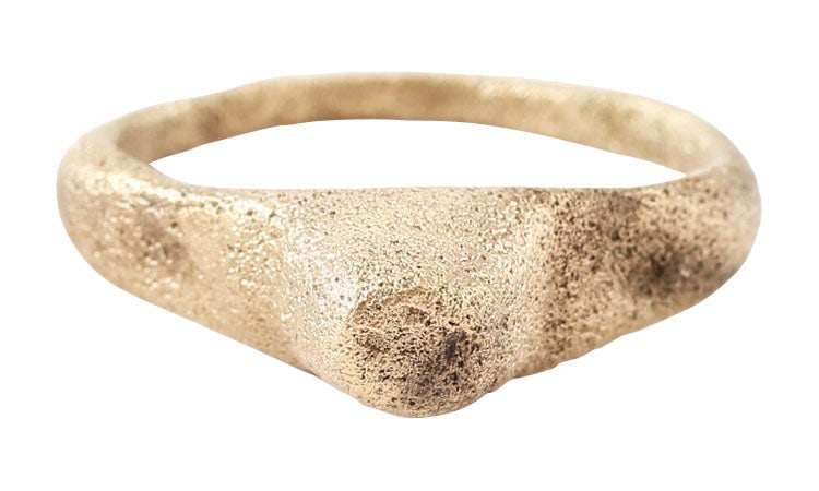 ROMAN PROSTITUTE'S RING, C.100-300 AD, SIZE 9: Gilt bronze, size 9. Rounded face band, 1.7mm width expanding to the shoulders. Large bezel of truncated pyramid form superficially imitating a gemstone and blatantly advertising the intentions of the