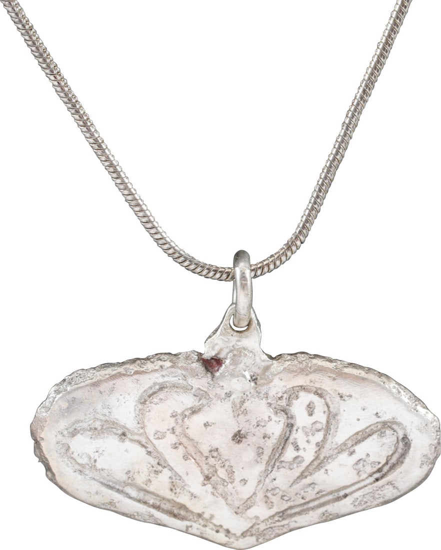 VIKING HEART PENDANT NECKLACE, C.900-1050 AD: Just over 1 ¼’ (1.27”) width, and with deep relief incised decoration. Heart form with central inscribed trefoil of abstracted and abbreviated form with the rounded edges scrolling