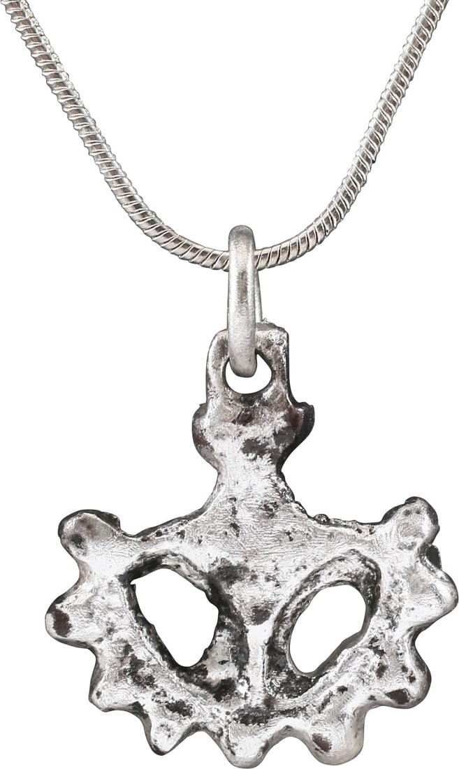 FINE ROMAN MYSTICAL PENDANT NECKLACE C.200-400 AD: Wheel form just under 7/8" diameter. Stylistically modeled in high relief as a partial 16-spoke wheel with a central hub, three (of four) spokes and nine nubs forming over half the wheel. The concept 